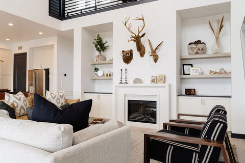Down to Earth Projects | Eden Residence - family room with grey sofa and black and white chairs  