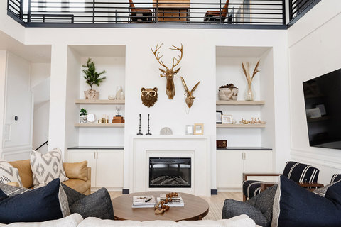 Down to Earth Projects | Eden Residence - family room with brass animals on walls with shelves 