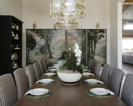 Down to Earth Projects | Utah Valley Parade at The Legacy at Meadow Ridge - dining room with wall art and large table and fabric chairs 
